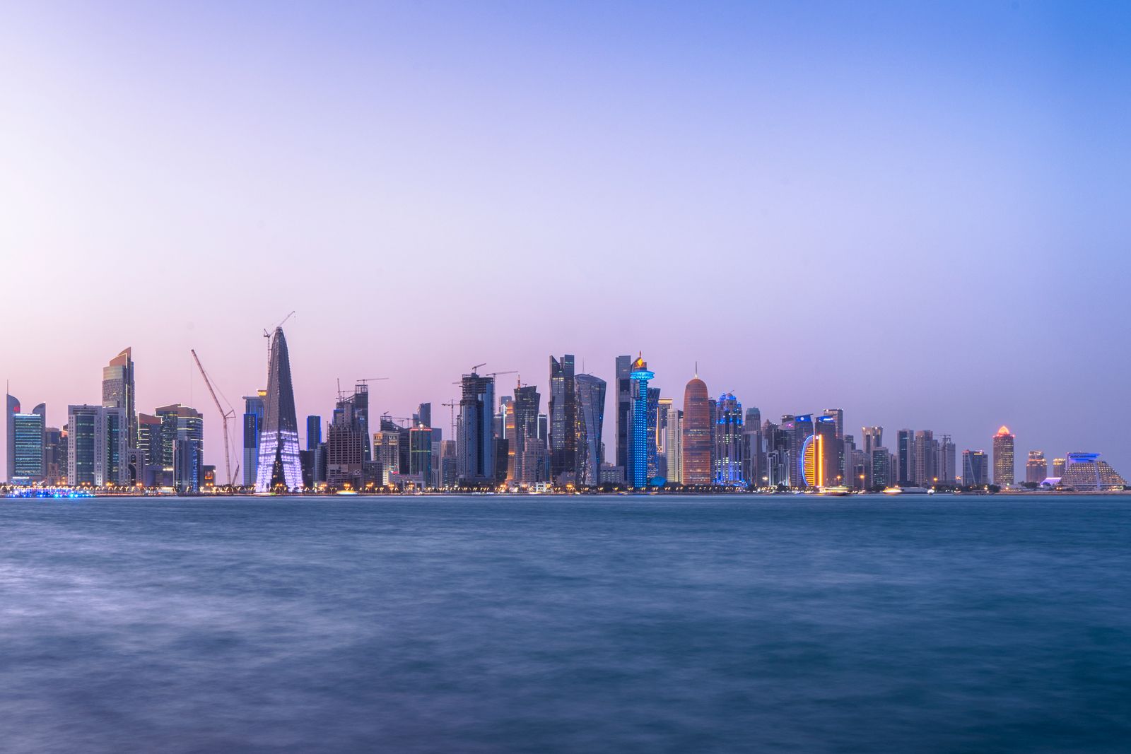 The Doha skyline at dusk seen across the water